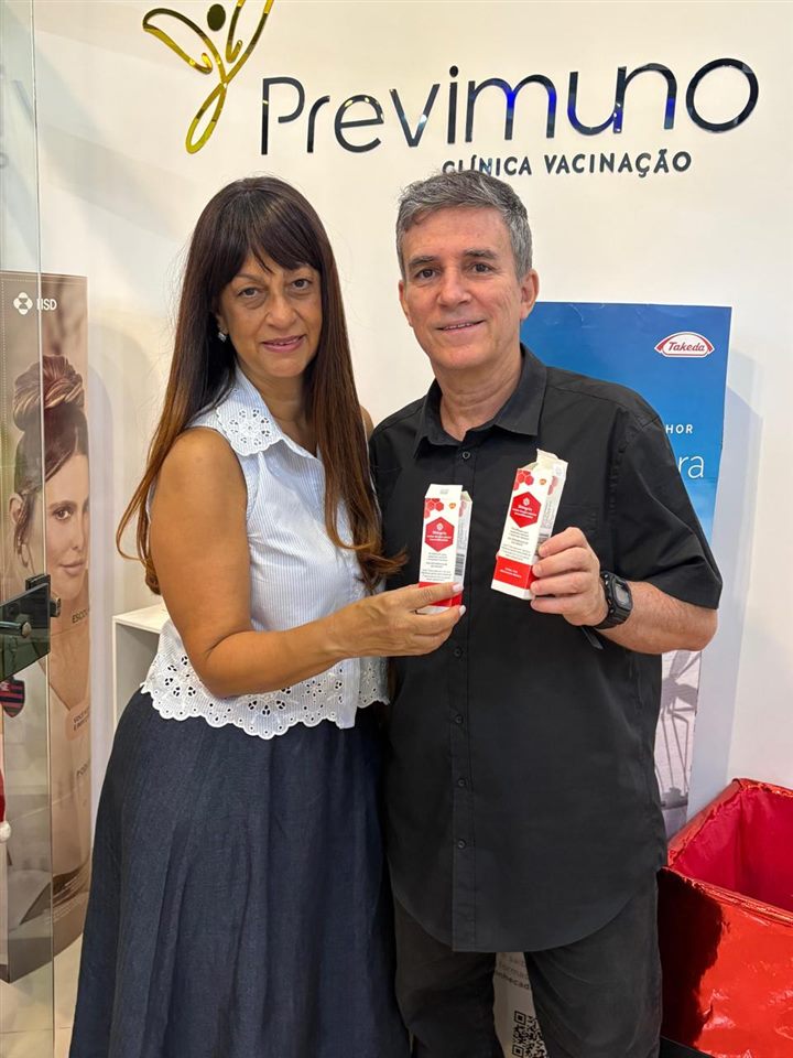 Casal com vacinas na recepção da clínica